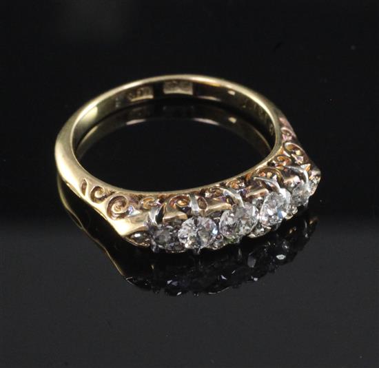 An early 20th century 18ct gold and graduated five stone diamond ring, size P.